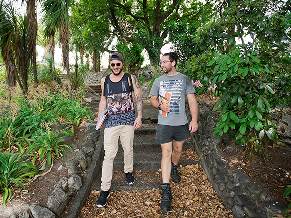 Two people walking in a garden